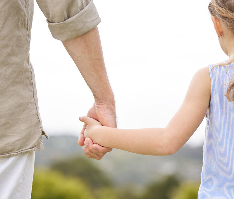 Father and daughter holding hands