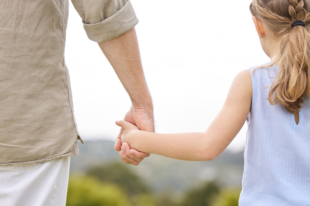 Father and daughter holding hands